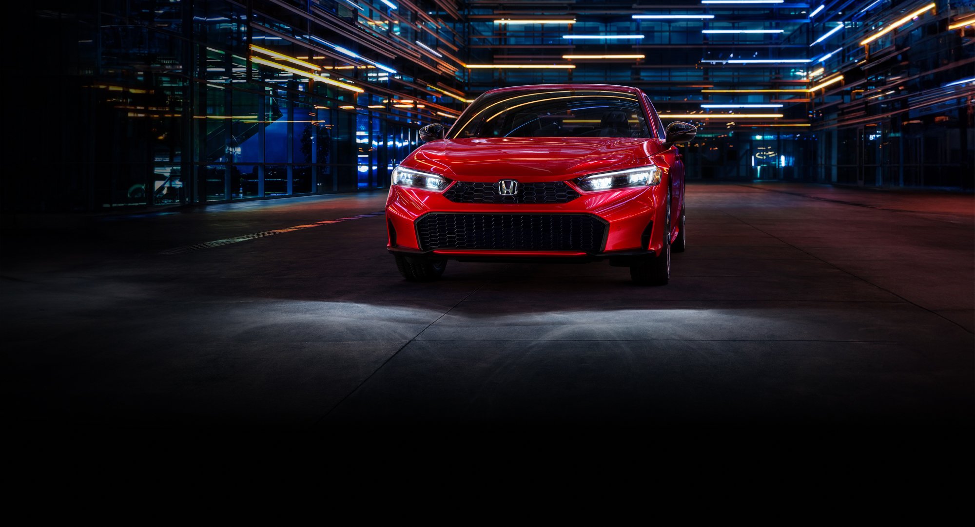 2025 Civic Sedan Sport Touring Hybrid in Rallye Red at straight front angle in outdoor environment.